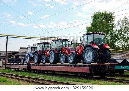 Farm Tractors Loaded On A Freight Train. Import/export Of The Agriculture And Farming Equipment. Log