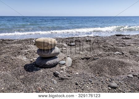 Sea Surf On The Beach With Black Volkanic Sand And Stones.