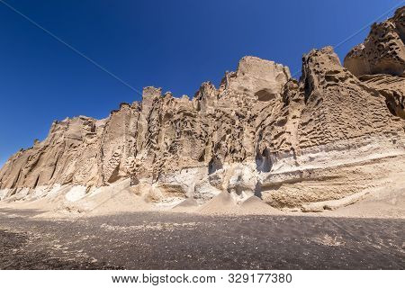 Canyon Mountains On Vlychada Beach On A Sunny Summer Day.