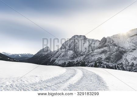Sunny Winter Scenery With Snow-capped Mountains Peaks, Snow-covered Nature, And Snowy Alpine Road, N
