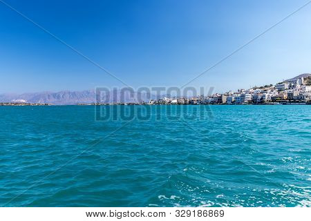 Agios Nikolaos On A Sunny Day With Clear Sea And Cliffs. Elunda.
