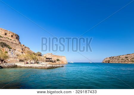 Spinalonga Fortress On A Clear Sunny Day. The Ruins Of Leprosolium.