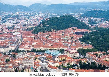 Aerial View Of Center City Graz From Helicopter Drone With Hill Schloßberg With Tower Uhrturm, Centr