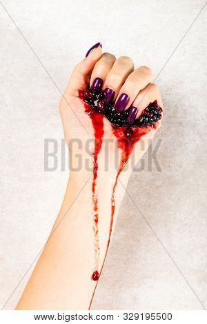 Stylish Trendy Purple Female Manicure. Young Woman Hands Are Squeezing Juice From Blackberries