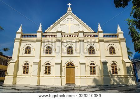 Front Of Santa Cruz Cathedral Basilica White Colonial Church With Blue Cloudless Sky In Kochi, Keral