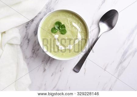 Bowl With Squesh Cream Soup On Murble Background