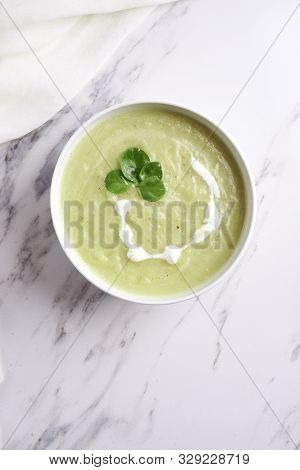 Bowl With Squesh Cream Soup On Murble Background