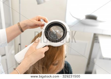 Dnipro / Ukraine - 04.27.2019: A Trichologist Examines The Condition Of The Hair On The Patients Hea