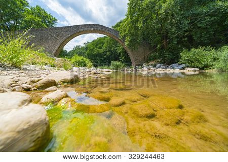 Historic Stone Single Arch Bridge At Zagori In Mountains In Central Greece.