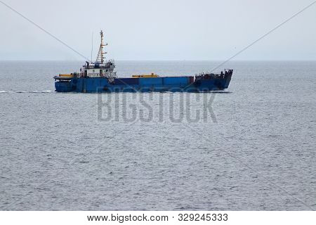 Landing Craft Ship Underway At Sea Transporting Vehicles, Containers And General Cargo. Ferry Equipp