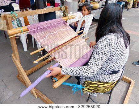 Cuenca, Ecuador - September 28, 2019: Ecuadorian Woman Is Weaving Scarf Or Macana By Hand With Cotto