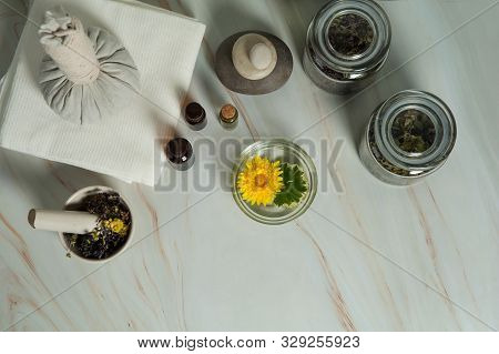 Aromatherapy And Spa Care. Dried Herbs, Small Bottles Of Essential Oils, Mortar And Pestle, Massage 