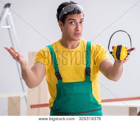 Worker showing the importnace of wearing noise cancelling headph