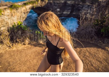 Young Woman Tourist Near Broken Beach In Nusa Penida, Indonesia Angels Billabong Beach. Popular Tour