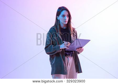 Modern Girl With Laptop, Tablet Computer. Free Creativity. A Young Blogger Makes A Home Office. Colo