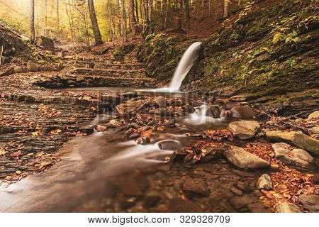 Autumn Mountain Waterfall Stream In The Rocks With Colorful Red Fallen Dry Leaves, Natural Seasonal 