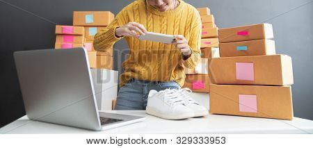Young Women Taking Photo To Shoes With Cell Telephone Or Smartphone Digital Camera For Post To Sell 