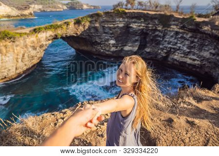 Young Woman Tourist Near Broken Beach In Nusa Penida, Indonesia Angels Billabong Beach. Popular Tour