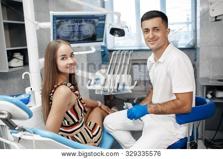 Dental Clinic. Reception, Examination Of The Patient. Teeth Care. Young Woman Undergoes A Dental Exa