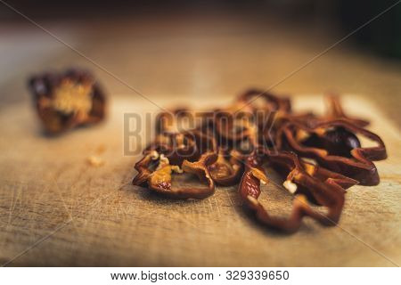 Chocolate Habanero Pepper (capsicum Chinense) Slices On A Wood Cutting Board. Healthy And Really Hot