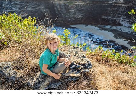 Young Boy Tourist Near Broken Beach In Nusa Penida, Indonesia Angels Billabong Beach. Popular Touris