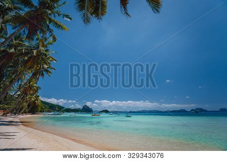 El Nido, Palawan, Philippines. Beach Coastline. Shallow Lagoon, Sandy Beach With Palm Trees. Travel 