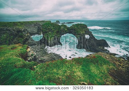Amazing Seascape, Gatklettur Basalt Rock Arch At The Volcanic Cliff, Atlantic Coast Of Arnarstapi In