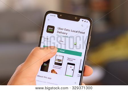 Warsaw, Poland - October 22, 2019: User Installing Uber Eats Food Delivery App On A Xiaomi F1 Pocoph