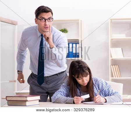 Male lecturer giving lecture to female student