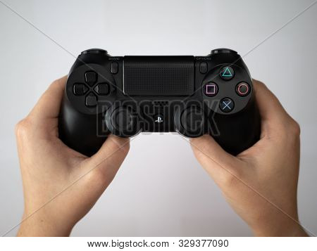 Uk, October 2019: Sony Dualshock Playstation 4 Games Console Controller Remote Being Held Over White