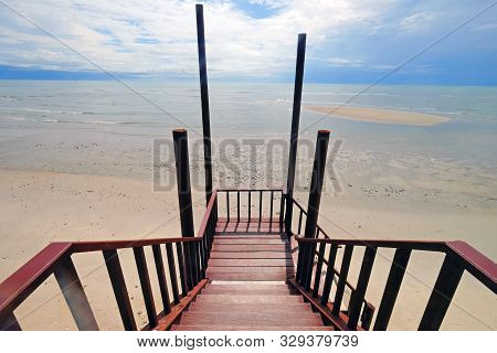 Straight View Of Wood Stairway Down To The Beach And Sea