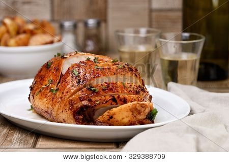 Sliced Into Slices Baked Turkey Breast  Close-up At The Dinner Table