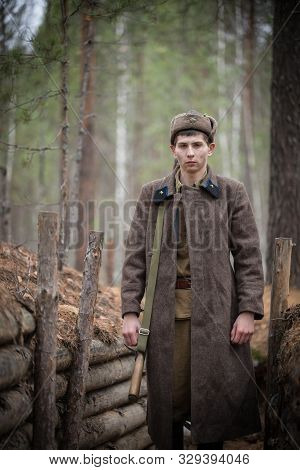 A Soldier Of World War Ii Is Standing In The Trench