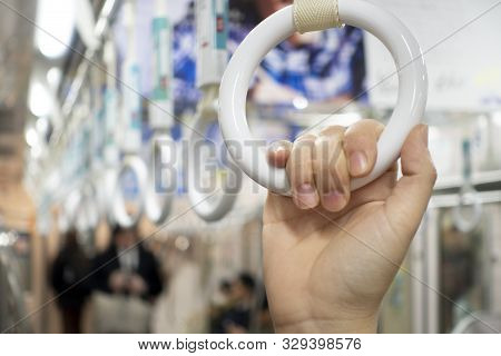 Holding Your Hand With Ring While Train Transportation For Safety Concept.