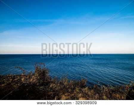Baltic Sea From Cliff In Mechelinki, Poland. Nature And Travel Concept. Copy Space On Blue Sky.