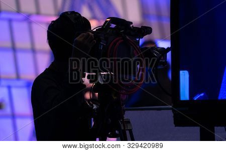 Behind The Scenes Of Movie Shooting Or Video Production. Cameraman Shooting The Film Scene With Came