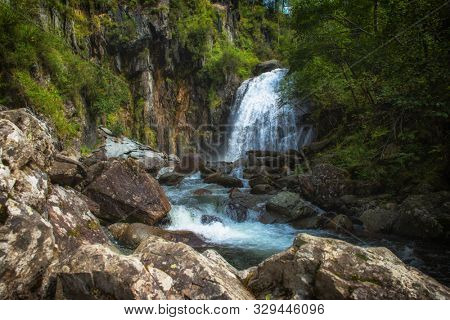 Korbu Waterfall at Lake Teletskoye in the Altai Mountains. The most famous lake waterfall