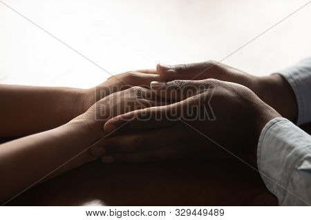 Close Up Millennial African Amarican Loving Man Holding Wifes Hands.