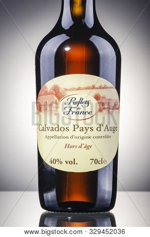 Bottle Of Calvados On Gradient Background. Calvados Is Kind Of Apple Brandy Manufactured In Normandy