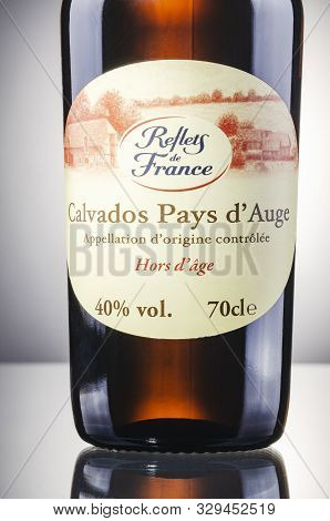 Bottle Of Calvados On Gradient Background. Calvados Is Kind Of Apple Brandy Manufactured In Normandy