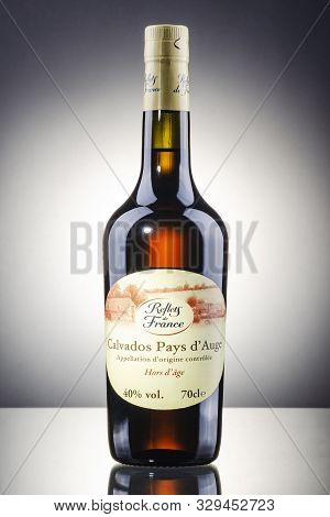 Bottle Of Calvados On Gradient Background. Calvados Is Kind Of Apple Brandy Manufactured In Normandy