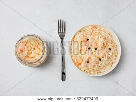 Homemade Sauerkraut. Fermented Food. Sauerkraut With Carrots In A Bowl With A Fork And A Glass Jar O