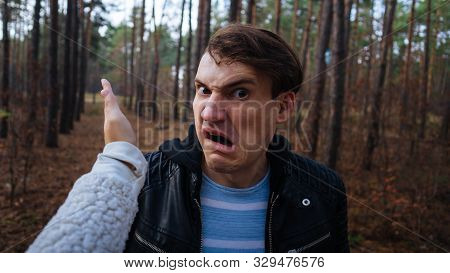 A Womans Hand Hits A Mans Face In The Autumn Forest. An Emotional Male Is Getting Slapped In Face, W
