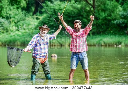 Fisherman With Fishing Rod. Activity And Hobby. Fishing Freshwater Lake Pond River. Bearded Men Catc