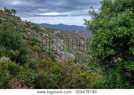 Empty Mountain Road In Catalunya, Spain. Serpentine Mountain Route In Europe On Cloudy Sky Backgroun