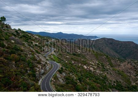 Beautiful Mountain Road In Catalunya, Spain. Serpentine Mountain Route In Europe On Cloudy Sky Backg