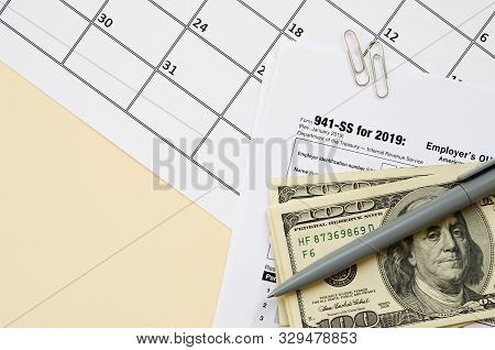 Irs Form 941-ss Employers Quarterly Federal Tax Return Blank Lies With Pen And Many Hundred Dollar B