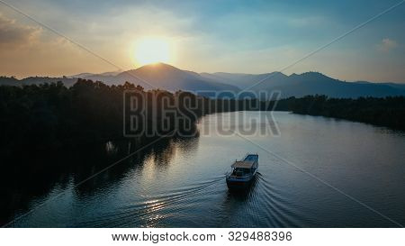 Beautiful Drone Shot Of A Boat On The Prek Kampot River At Sunset During A River Cruise In Kampot, C