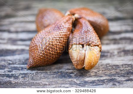Salak On Wooden Background / Salak Tropical Fruit Salacca Zalacca Or Snake Fruit Palm