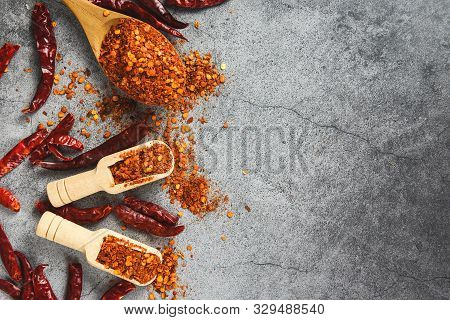 Cayenne Pepper On Wooden Spoon Spices And Dried Chilli Peppers Background / Group Of Red Hot Chilli 